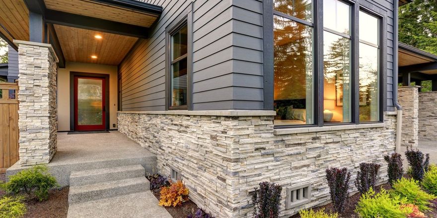Premium fiber-cement siding and stacked stone masonry on a modern Oklahoma home